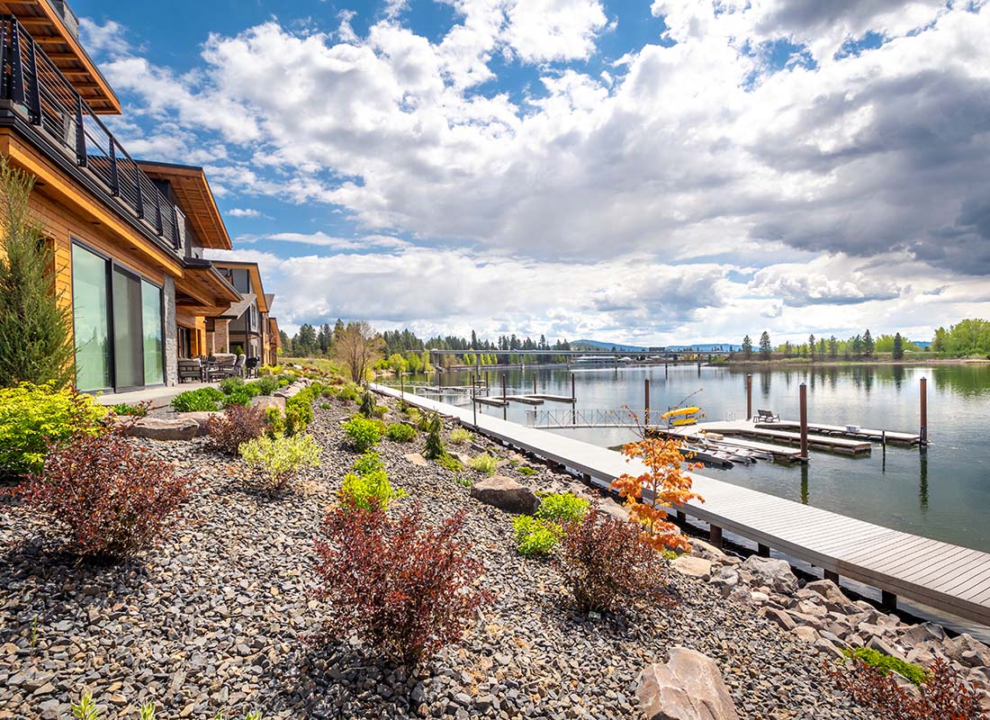 Insurance Solutions - View of Luxury Lake Front Homes in Idaho with a Private Dock and Beautiful Landscaping on a Sunny Day