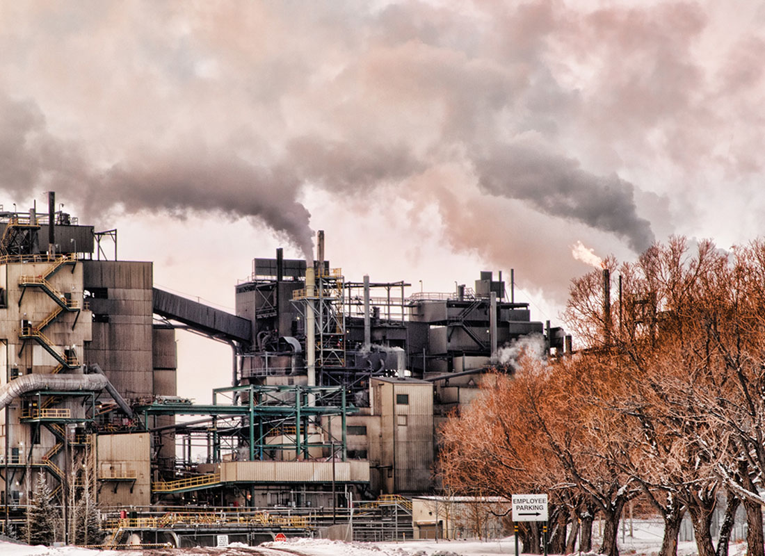 Smithfield, UT - View of an Energy Production Facility in Smithfield Utah During the Winter with Smoke Against a Clear Sky